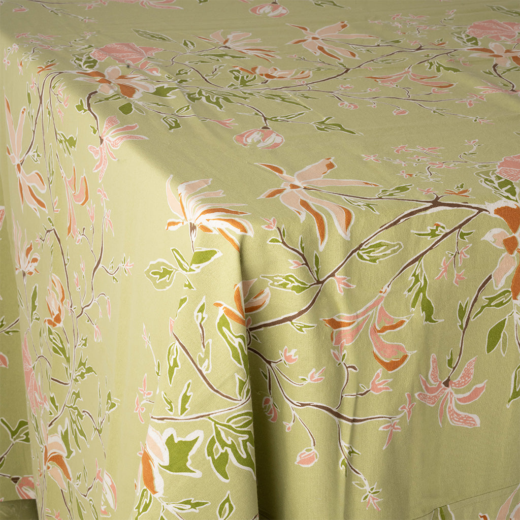 close up image of a green and orange botanical tablecloth