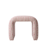 Pink patterned ottoman on a white background