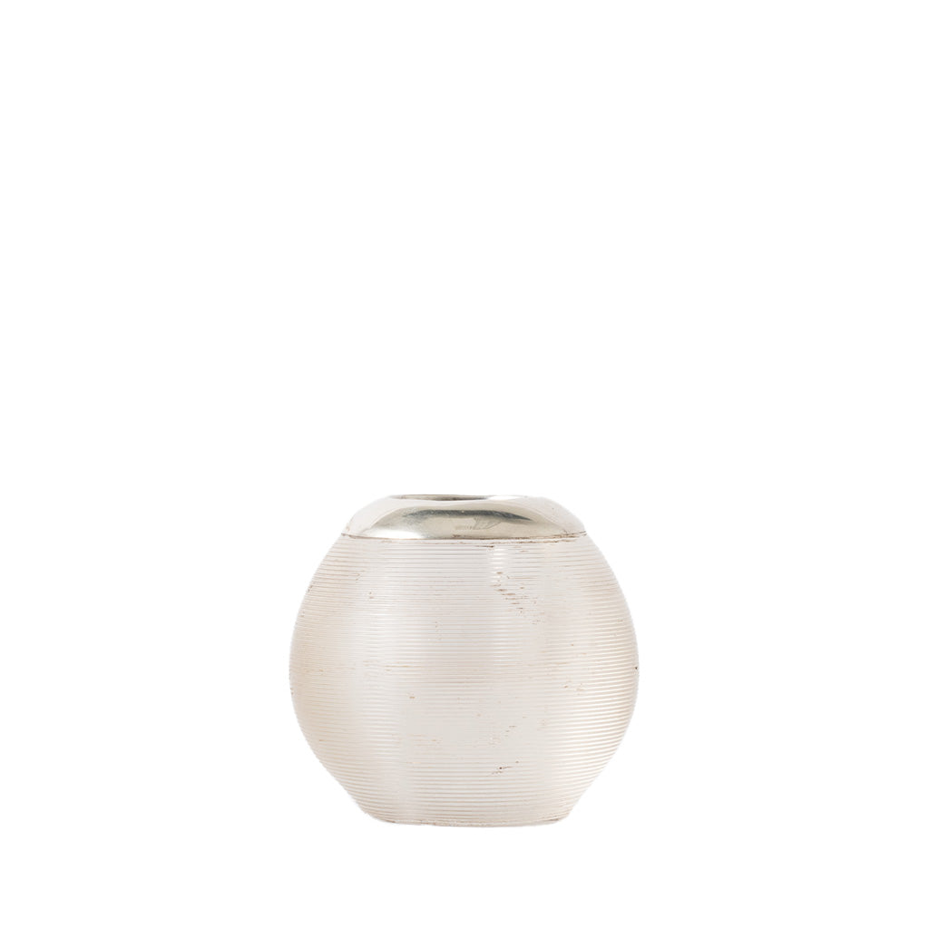 A small round textured glass match holder with a ribbed, matte off-white body and a contrasting metallic silver lid, set against a solid white background.