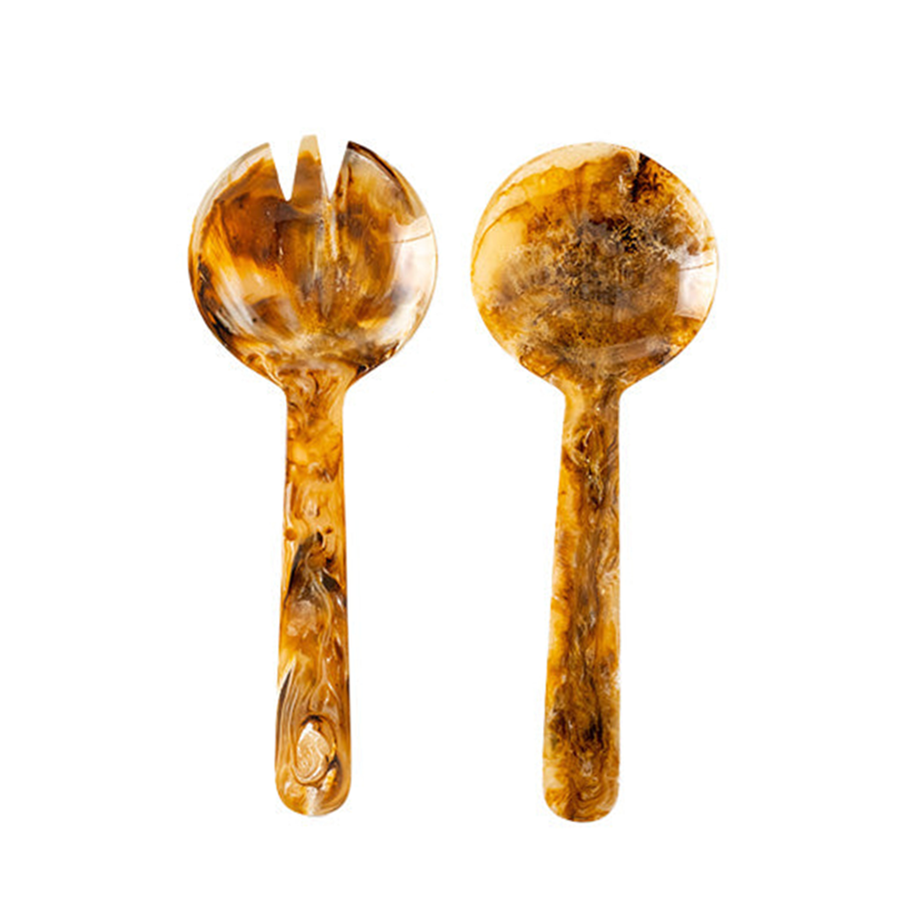 Two-piece salad serving set in warm amber brown resin with natural marbled variations. Includes a rounded serving spoon and coordinating fork, each with a glossy finish and organic patterning on a white background