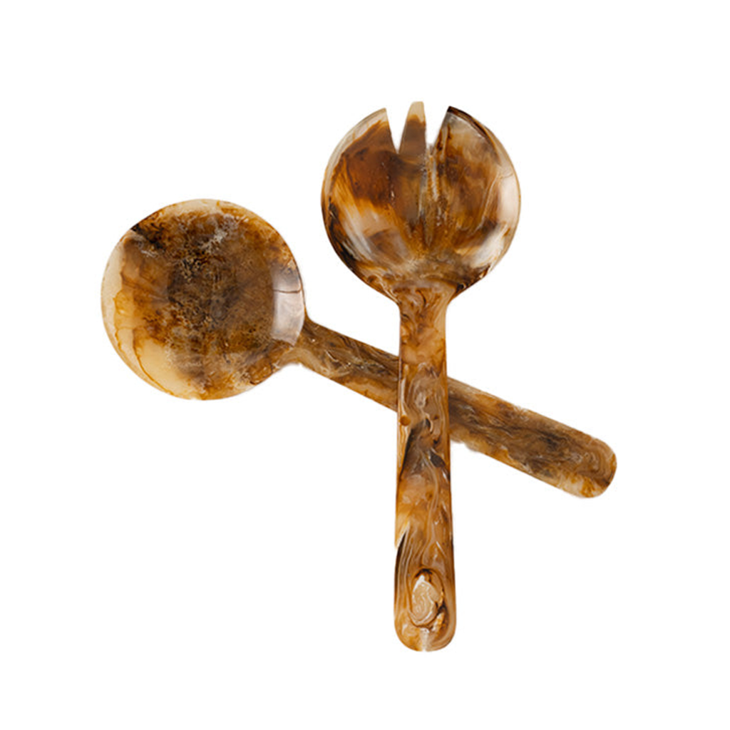 Two-piece salad serving set in warm amber brown resin with natural marbled variations. Includes a rounded serving spoon and coordinating fork, each with a glossy finish and organic patterning.