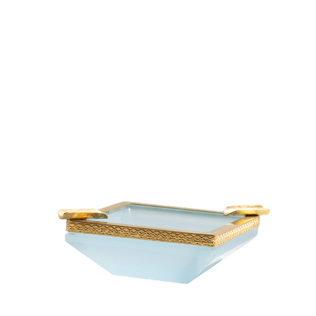 Light blue glass dish with gold rim on a white background