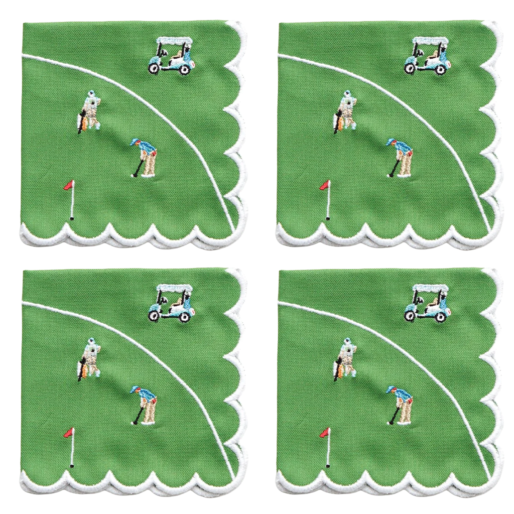 Four square green napkins with scalloped white edges, each printed with a golf course scene featuring a golfer, flag, hole marker, and golf cart.