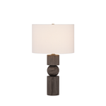 A modern table lamp with a cylindrical and spherical dark wood base and a white drum shade, shown against a plain white background.