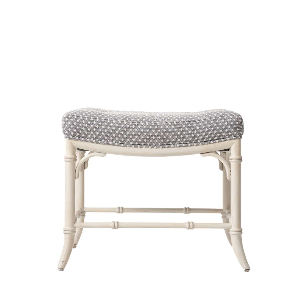 White bench with patterned cushion on a white background