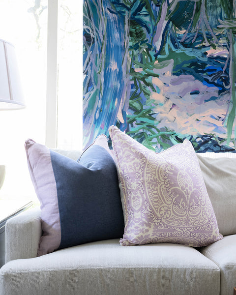 layered lavender pillows on sofa