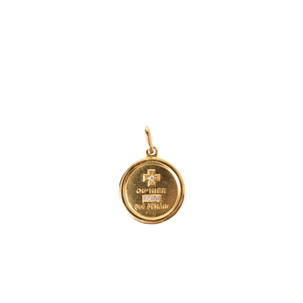 Gold pendant with engraved text on a white background