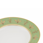 Green plate with gold leaf patterns on a white background