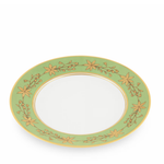 Angled green decorative dinner plate with gold leaf pattern on a white background