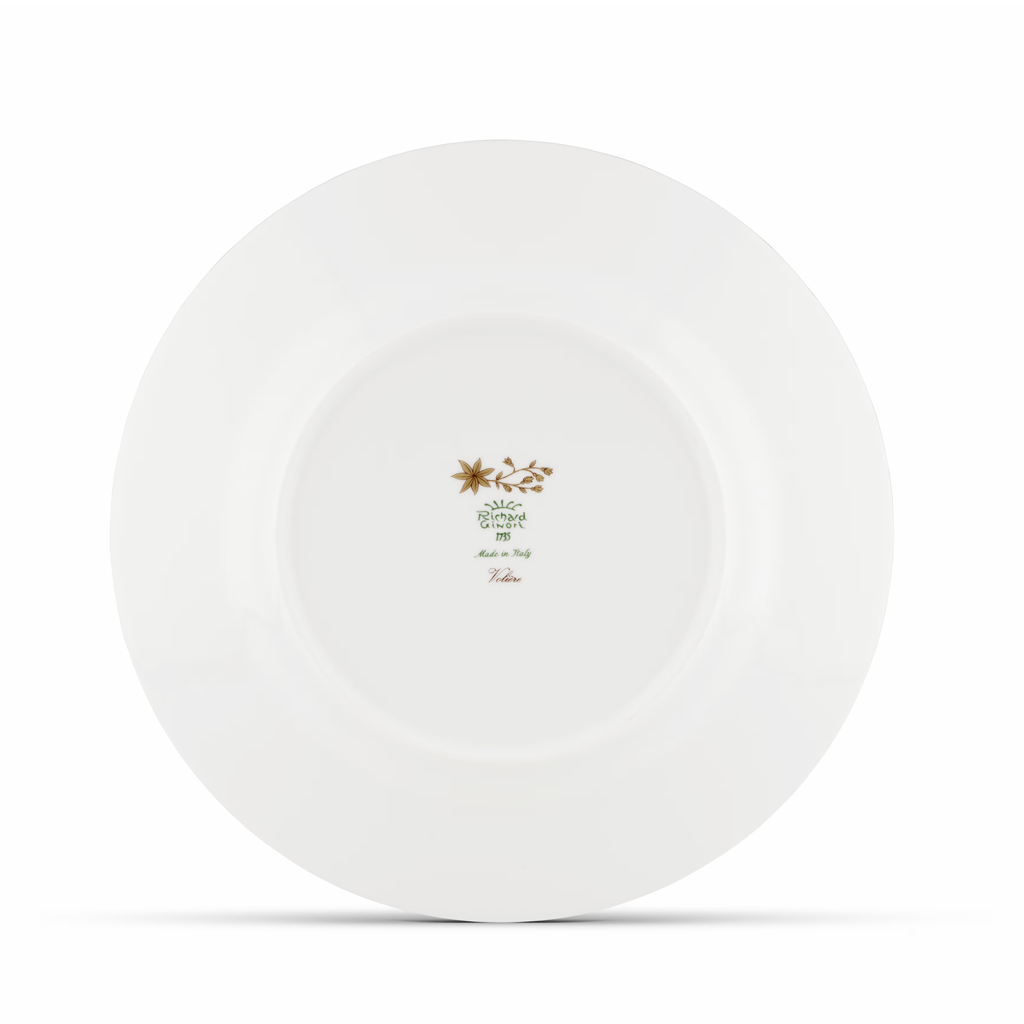 White ceramic plate with a gold logo and text on a white background