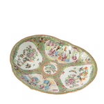 Decorative ceramic plate with colorful floral and figurine designs on a white background