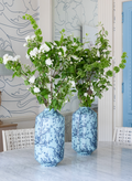 two turquoise and and blue vases filled with flowers