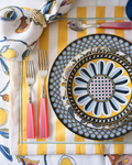 yellow stripe placemat being used with plates and flatware 