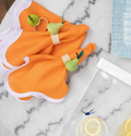 tangerine napkins being used with pear napkin rings 