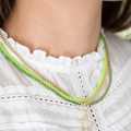 green tennis necklace styled