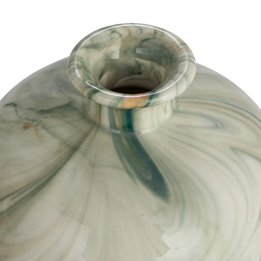 Marbled glass with green and beige swirls on a white background