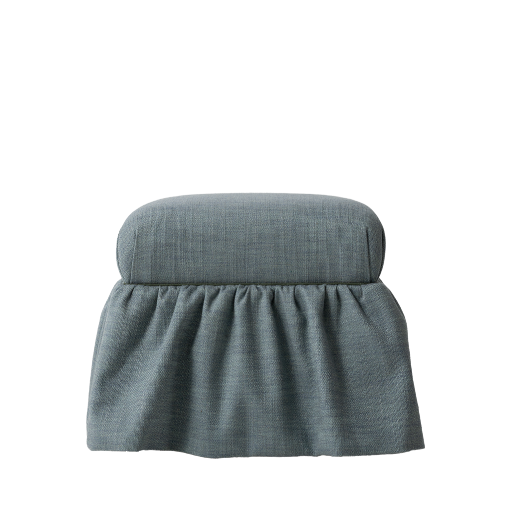 Blue fabric ottoman with a cushion on a white background
