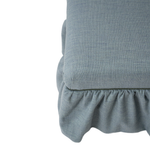 Blue upholstered ottoman with ruffle skirt