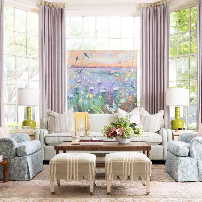 store display with blue patterned chairs, ottomans, light green sofa, and bright green lamps