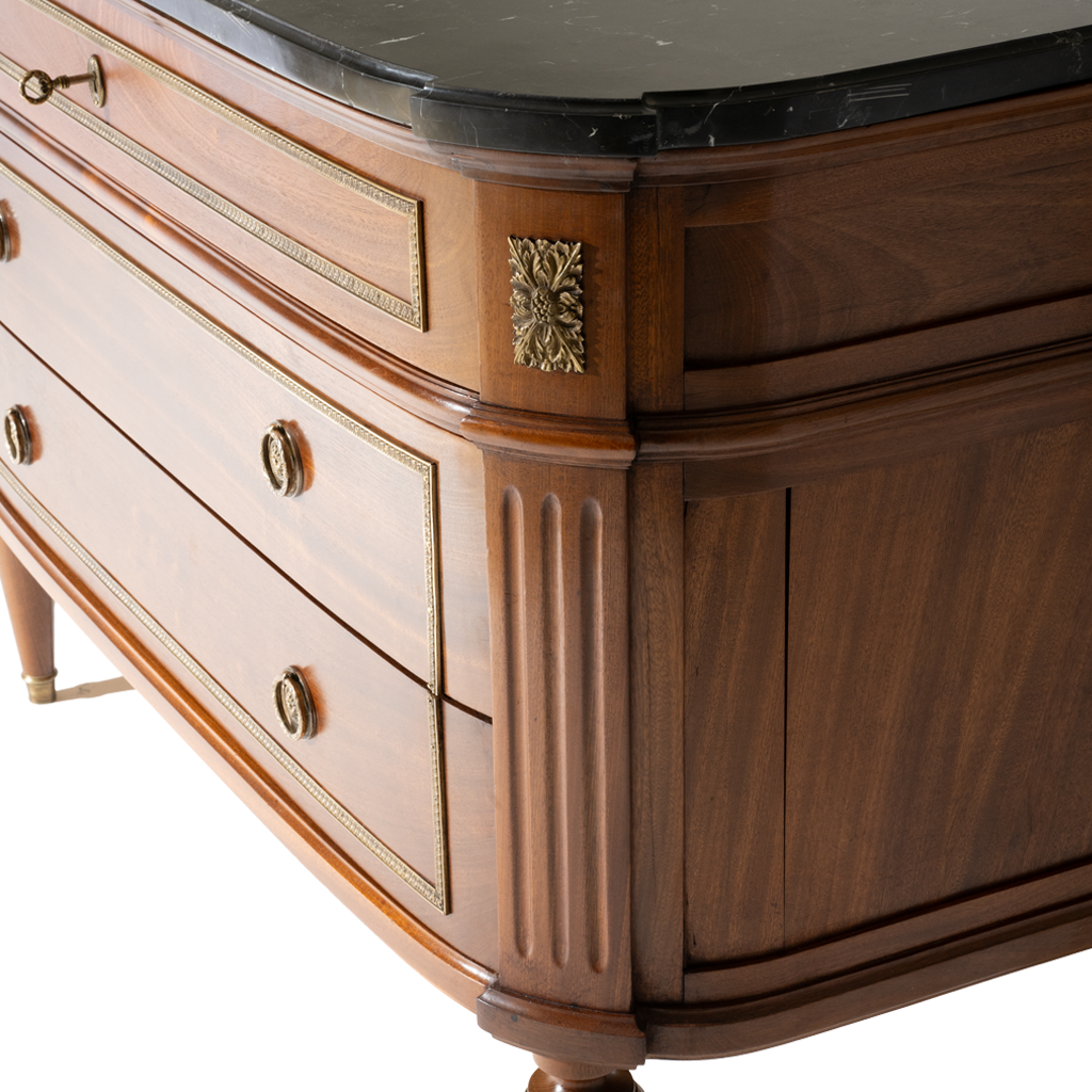 Close-up of a wooden dresser with marble top