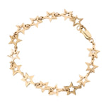 A gold star-link bracelet with openwork five-point stars and a lobster clasp, shown on a plain white background.