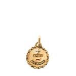 A gold-toned round pendant charm with a faceted edge, featuring a cross, the name 'OCTAVIER', and the words 'QUE DEMAIN' on a plain white background.