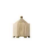 A small hexagonal ceramic lidded container or candle holder with vertical ridges and a pointed lid, shown on a plain white background.