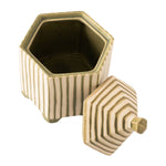 Hexagonal ceramic container with a matching lid, featuring vertical olive green stripes on a warm cream background, shown on a plain white background.