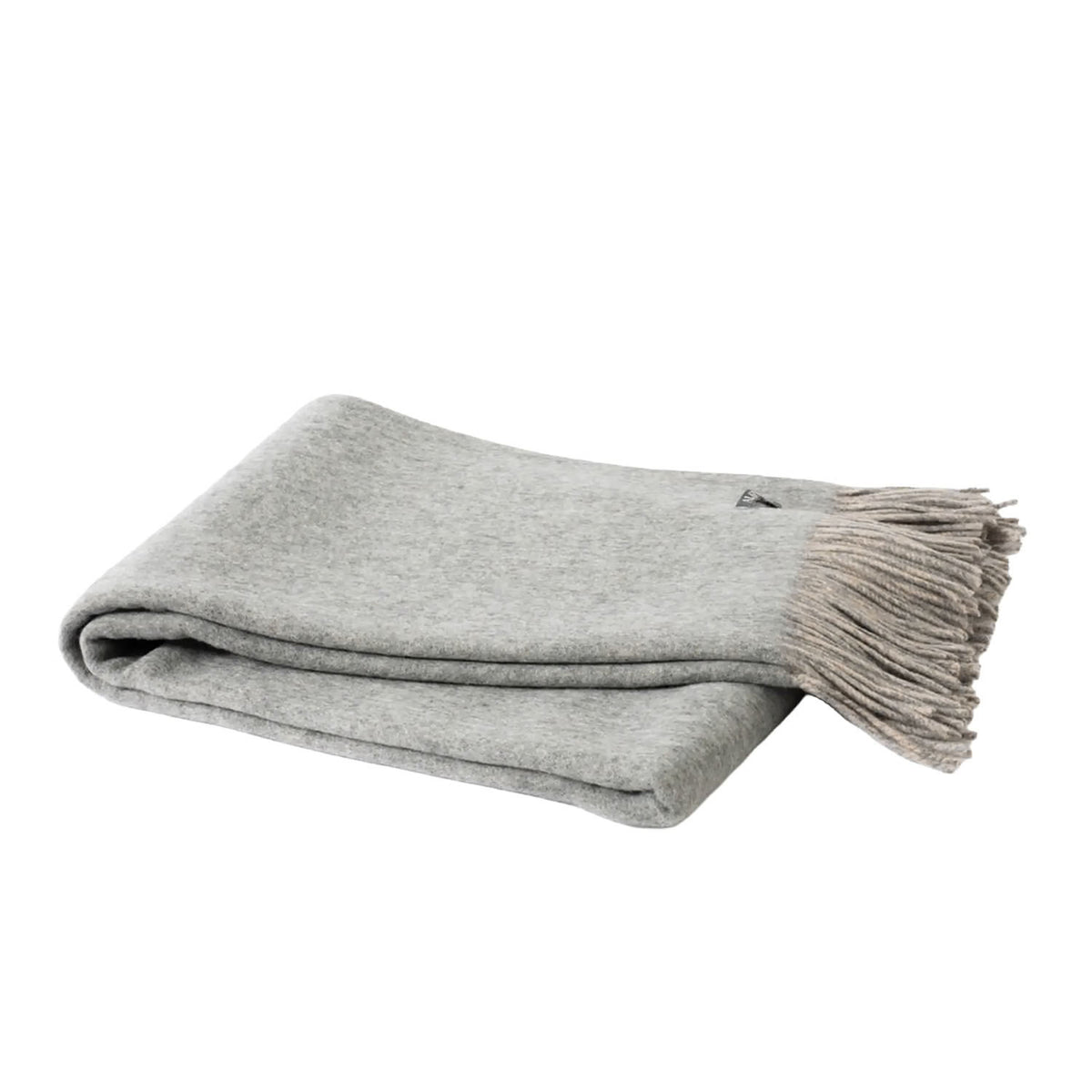 A folded light gray knit throw blanket with fringed edges, shown on a plain white background.