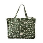 A dark green crinkled tote bag with a cream-colored pattern of horseshoes, stars, and stars-and-stripes motifs, featuring a small brand patch on the front.