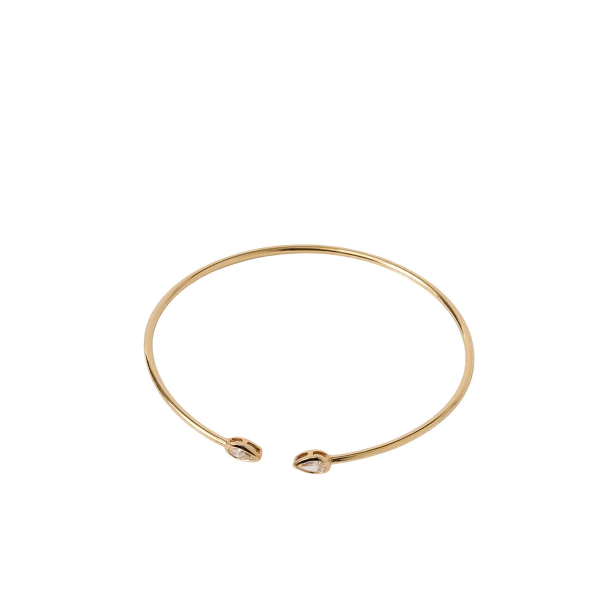 A thin gold open cuff bangle bracelet with a small oval charm at each end, shown on a plain white background.