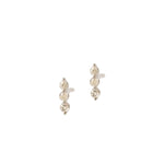 A pair of silver stud earrings featuring three vertically stacked, bezel-set round clear gemstones on a plain white background.