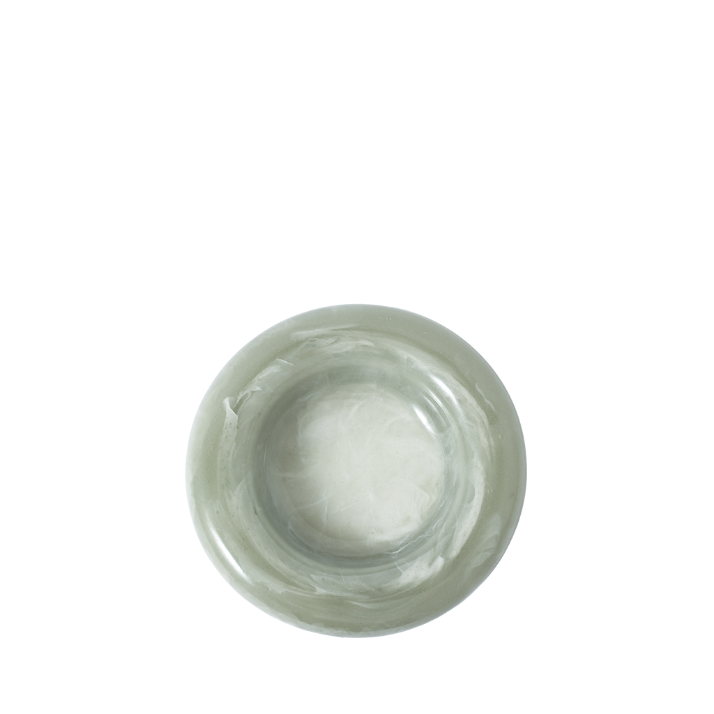 Green resin catch all dish on a white background