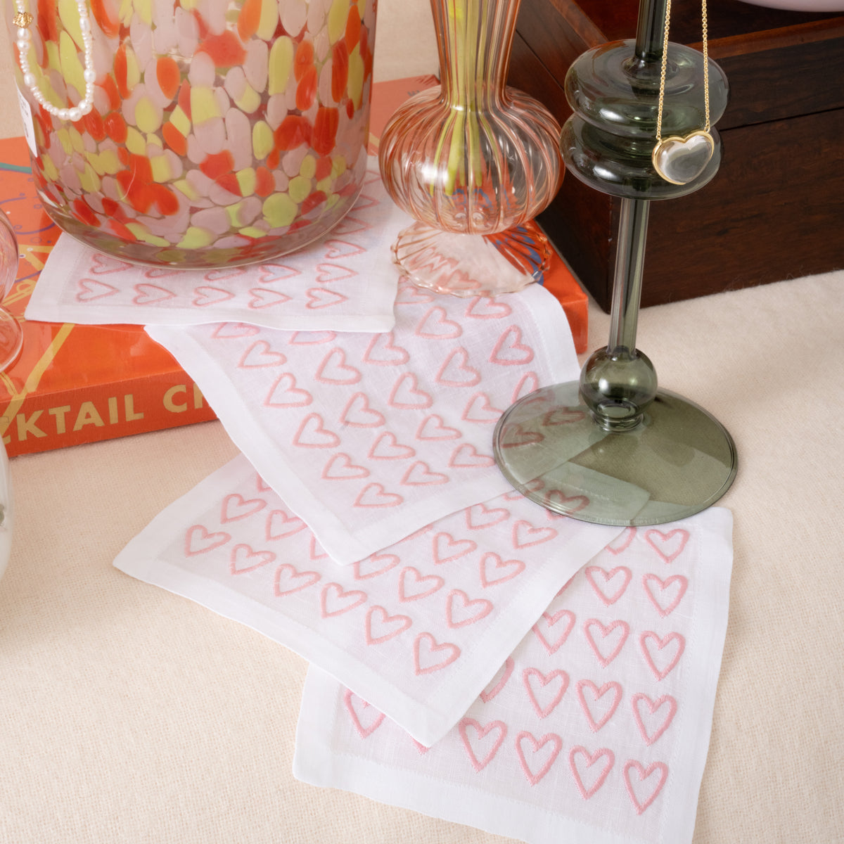 White cocktail napkins with pink embroidered hearts