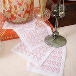 White cocktail napkins with pink embroidered hearts