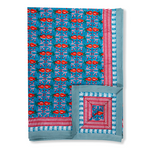 blue green tablecloth with red and pink details
