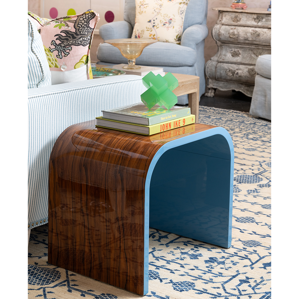 Wooden side table with blue edge in a living room setting