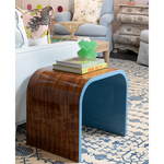 Wooden side table with blue edge in a living room setting