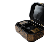 An open octagonal lacquered wooden jewelry box with a black interior and gold-toned floral patterned exterior, shown on a plain white background.