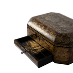 A vintage octagonal lacquered box with a hinged drawer pulled open, featuring an intricate gold and black landscape scene hand-painted on a dark brown base, set against a plain white background.