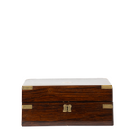 A rectangular wooden box with a dark brown wood grain finish, brass corner protectors, and a small central lock, photographed against a plain white background.
