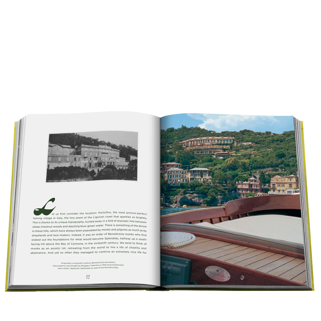Open book showing a scenic view of a coastal town with houses on a hillside.