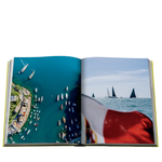 Open book showing images of sailboats on water