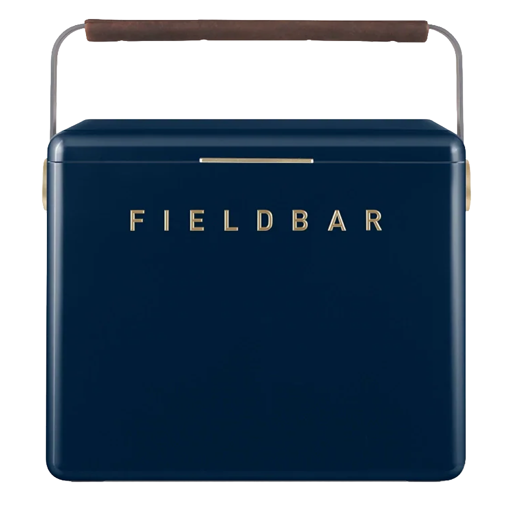 A navy blue FIELDBAR cooler with gold lettering, rounded edges, and a slim gold latch is shown against a white background. It features a curved metal handle wrapped with a brown leather grip, giving it a modern, premium appearance.