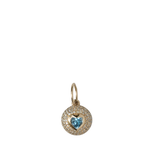 Gold pendant with a heart-shaped blue gemstone on a white background