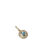Gold pendant with a blue gemstone on a white background