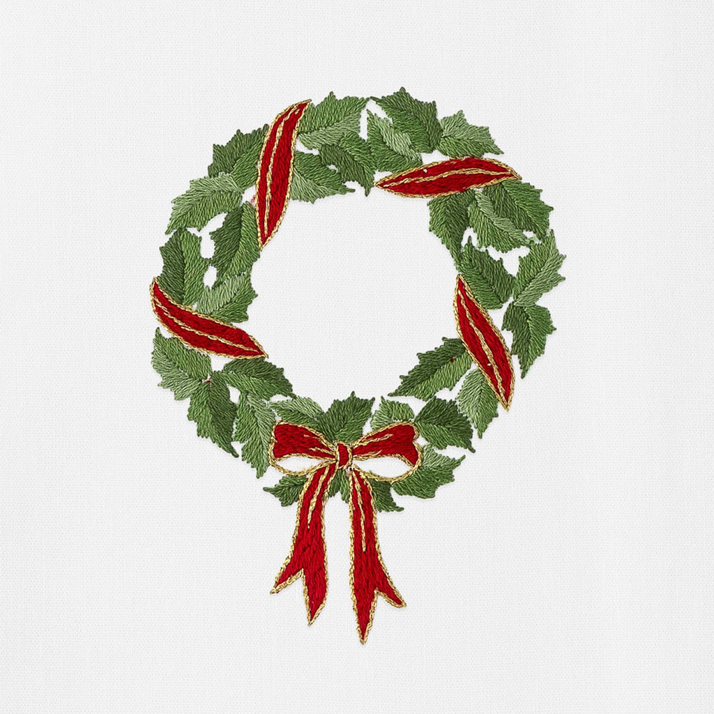 White tea towel with green holly wreath with red ribbon 