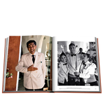 Open book showing a page with a man in a white uniform and another with a black and white photo of two people in formal attire.