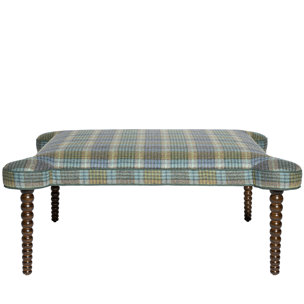 Plaid ottoman with wooden legs on a white background