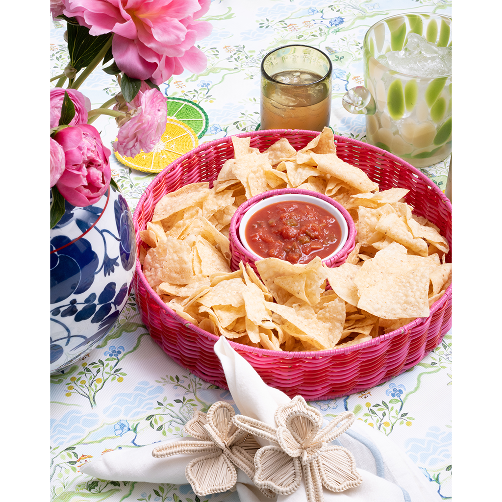 pink chip and dip server with salsa on a blue patterned tabelcloth
